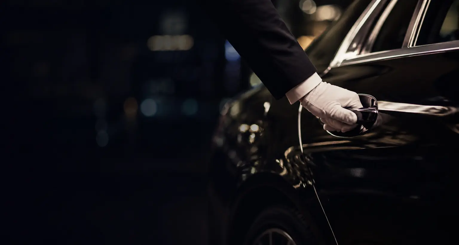 Chauffeur opening the door of a luxury vehicle
